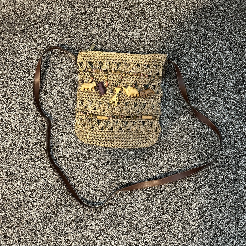 Cream and brown crochet bag with wooden animal charms and leather strap